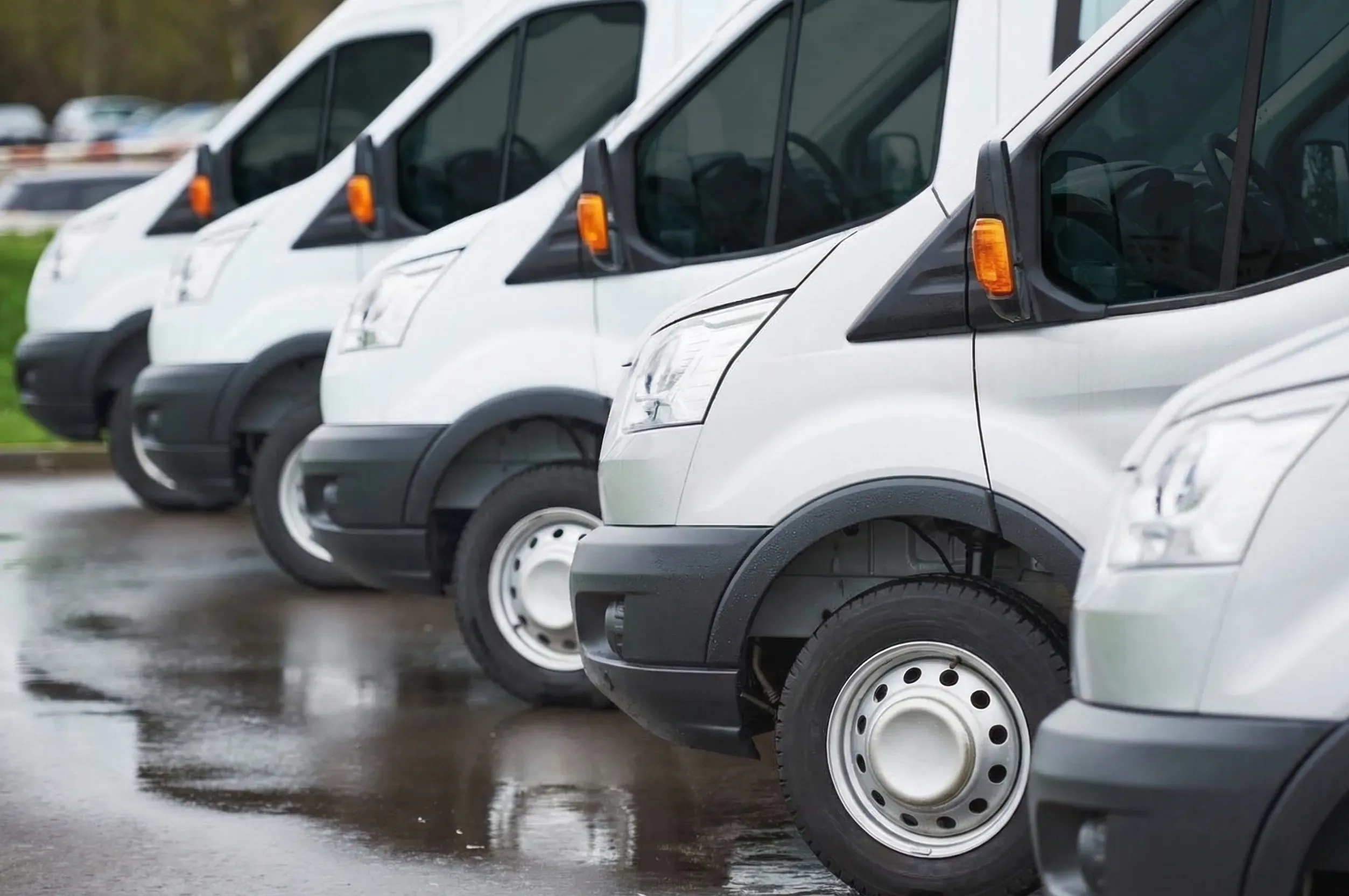 Tinted commercial fleet vans parked in a row